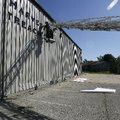 Dwight Heitt of Prairie Grove puts up a new sign for Valley Harvest Community Outreach Center in Rog...