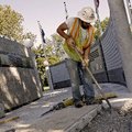 Adam Murray of Rogers digs out a foundation for a new section of the Veterans Wall of Honor in Bento...