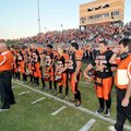 Gravette head coach Bill Harrelson, right, wiped tears from his face after a moment of silence in me...