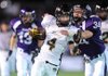 Bentonville junior Dakota Baggett (4) is tackled by Fayetteville junior Drake Harrison after returning the opening kickoff to the Fayetteville 34 yard line during the first quarter of play Friday at Harmon Field. 