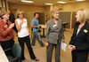 Brenda Green, NorthWest Arkansas Community College associate dean for learner services for Washington County, right, speaks with NWACC President Becky Paneitz as staff members give tours of the college's newly dedicated Washington County Center on Friday in Springdale. 