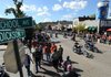 Motorcyclists and pedestrians make their way along West Dickson Street during the 10th annual Bikes, Blues & BBQ Motorcycle Rally on Saturday in Fayetteville. 
