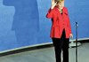 German Chancellor Angela Merkel, top candidate of the Christian Democratic Union Party, waves after the German general elections in Berlin on Sunday.