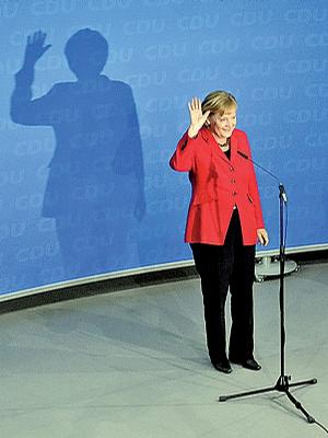 German Chancellor Angela Merkel, top candidate of the Christian Democratic Union Party, waves after the German general elections in Berlin on Sunday.
