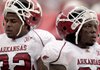 Arkansas Razorbacks Bret Harris and Jerico Nelson watch in the final minutes of the Razorbacks' 35-7 loss to No. 3 Alabama in Tuscaloosa, Ala., on Saturday. Arkansas Coach Bobby Petrino said that the Razorbacks have "got to win" against Texas A&M next Saturday.