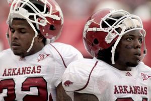 Arkansas Razorbacks Bret Harris and Jerico Nelson watch in the final minutes of the Razorbacks' 35-7 loss to No. 3 Alabama in Tuscaloosa, Ala., on Saturday. Arkansas Coach Bobby Petrino said that the Razorbacks have "got to win" against Texas A&M next Saturday.