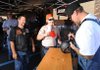 Jesse James, right, owner of West Coast Choppers and star of several motorcycle-related television shows, autographs a motorcycle helmet for Dena and Frank Smith of Joplin, Mo., during a stop to promote James' new line of clothing Sunday at the Wal-Mart Supercenter on West Martin Luther King Jr. Boulevard in Fayetteville. 