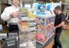 Tim Pennington, left, pulled out some scratch-off tickets for Calvin Clary at the White Oak Station on Southwest Regional Airport Boulevard in Bentonville on Monday.