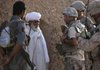 Afghan-American translator Waheed Kazenpoor of California translates Monday for U.S. troops as they speak with a local villager during a joint Afghan-U.S. patrol in an area frequented by Taliban militants in the Nawa district, Helmand province, of southern Afghanistan.