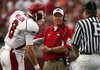 Arkansas Coach Bobby Petrino talks with linesman Johnny Crawford about one of the 11 penalties assessed against the Razorbacks in Alabama's 35-7 victory Saturday. Arkansas and Texas A&M are two of the most heavily penalized teams in the nation.