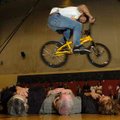 <b>Bikes, Books & BBQ</b>
Rich Wieber jumps over Holt Middle School counselor Jane Corrigan, from l...