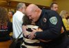 Sgt. Creston Mackey, with the Fayetteville Police Department, gets a hug from his mother-in-law, Janet Delany, Tuesday after a promotion ceremony held by the police department in City Hall. Mackey is one of four officers promoted to sergeant during the ceremony. 

