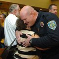 Sgt. Creston Mackey, with the Fayetteville Police Department, gets a hug from his mother-in-law, Jan...