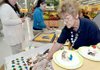 Juanita Kaufman served cake at the Bentonville Wal-Mart Supercenter on Wednesday to celebrate the store's remodeling.


