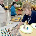 Juanita Kaufman served cake at the Bentonville Wal-Mart Supercenter on Wednesday to celebrate the st...