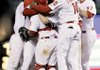 Philadelphia players gather around catcher Carlos Ruiz, outfielder Ben Francisco (10) and pitcher Chad Durbin (37) to celebrate after beating Houston 10-3 to clinch the National League East title.