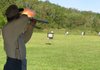 The flintlock rifle of Mike Brisco of Marshfield, Mo., belches fire as he shoots offhand at targets during the 54th annual Saunders Memorial Black Powder Match held last weekend at Luther Owens Memorial Park in Berryville. The match attracted shooters from five states.

