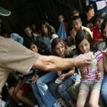 Paul Ahrens (cq) of Lamar gives samples of fleece to 4th graders, including Emelie Fincher, 9 (strip...