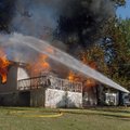 West Fork firefighters spray water on a house fire Wednesday at 10050 Fairview Lane near Greenland. ...