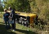 Springdale Athletic Director Annette Scoggin, left, talks with Dennis DeBusk Friday after a bus carrying the Springdale senior high football team rolled over near the intersection of Old Missouri Road and Zion Road in Fayetteville. 