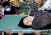 Rescuers pull teacher Suci Ravika Wulan Sari from a razed building Friday in Padang, Indonesia. 
