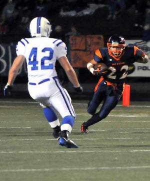 Heritage receiver Travis Entwisle headed upfield after a catch as Rogers linebacker Max Muirhead moved in to make the tackle during Friday's game at Gates Stadium in Rogers. Entwisle had eight catches for 51 yards in the War Eagles' 24-9 win. 

