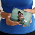 Consuelo Santillano West Fork holds an undated family picture - Onesimo "Nick" Santillano (left), ho...