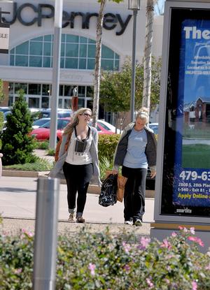 Lindley Summers, left, and Samantha Rush shopped at the Pinnacle Hills Promenade in Rogers on Friday.
