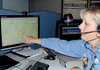 Dispatcher Luan Rogers points to a locator map pinpointing the area from which a cell-phone caller dialed 911 in Pine Bluff.