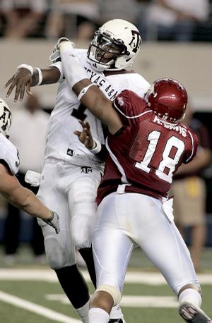 Arkansas running back Ronnie Wingo avoids Texas A&M defender Von Miller on his way to a 62-yard touchdown run in the fourth quarter, ending the Razorbacks' scoring.
