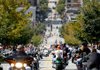 Bikers cruise along Dickson Street in Fayetteville during the 10th annual Bikes, Blues & BBQ Motorcycle Rally last month. Getting an accurate count on the number of attendees is a challenge, but organizers say the event has had continued growth.