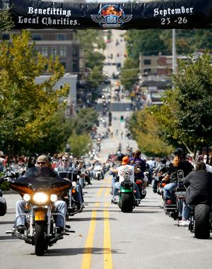 Bikers cruise along Dickson Street in Fayetteville during the 10th annual Bikes, Blues & BBQ Motorcycle Rally last month. Getting an accurate count on the number of attendees is a challenge, but organizers say the event has had continued growth.