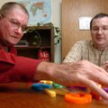 Loyd Smith picks out letters he can remember with reading tutor Jim Mears on Tuesday at the Ozark Li...