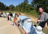 Artist Eugene Sargent repairs the bell on a train sculpture that he made as a part of the newly dedicated Reading Railroad on Saturday at the Botanical Garden of the Ozarks.