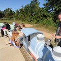 Artist Eugene Sargent repairs the bell on a train sculpture that he made as a part of the newly dedi...