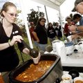 A cup o' red Brandy VanEaton of Springdale serves her chili for the judges Saturday during the seven...