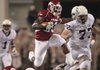 Arkansas's De'Anthony Curtis leaps over Texas A&M defenders
in second quarter action at Cowboys Stadium in Dallas Saturday.
