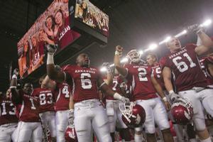 Arkansas players celebrate a 47-19 win over Texas A&M in Cowboys Stadium on Saturday.