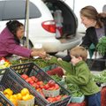 <b>Fresh purchase</b>
Parker Nelson, 3, hands money to Fayetteville Farmers' Market vendor Ia Lor a...