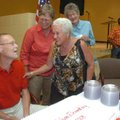 Bob Folsom, left, talks with Marie Easterling, right, and Sharon Mullen, center, during a dedication...