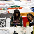 Cha'koya Smith (left) and Ashley Boyd, both University of Arkansas freshmen, look over T-shirts hang...