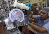 Gilberto Bancayan puts a lid on a “party pail” of Kroger brand ice cream at the Kroger Co. Springdale Ice Cream and Beverage plant in Cincinnati in August.