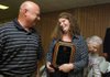 Amy Simco, right, with Arvest Bank’s West Fork branch, talks with Kenny Yates, with the Fayetteville Police Department, Tuesday after Simco received the Outstanding Citizen Award during the Washington County Sheriff’s Office promotion and awards ceremony in Fayetteville. Simco was honored for alerting a customer to a money scam earlier this year.