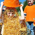 Josh Chester, 6, of Bella Vista watched as Lundyn Lute, 7, of Bella Vista poured a bucket of corn ov...