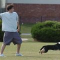 Lance Strother gets ready to throw a tennis ball for his border collie, Loka, to chase down Wednesda...