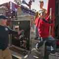 All in a day’s work Bella Vista firefighter Brandon Early watches Jamione Thompson (right), 6, and B...