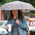 Jessica Lynch of Fayetteville tried not to get wet as she walked across the downtown Bentonville Squ...