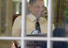 President Barack Obama takes a call in the Oval Office on Friday before speaking to the nation about his Nobel Peace Prize.