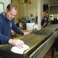Fayetteville firefighter Josh Hooten cleans grills Thursday in preparation for the fire department’s...