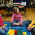 Lindsey Gentry, a student with the University of Arkansas childhood education program, from right, p...